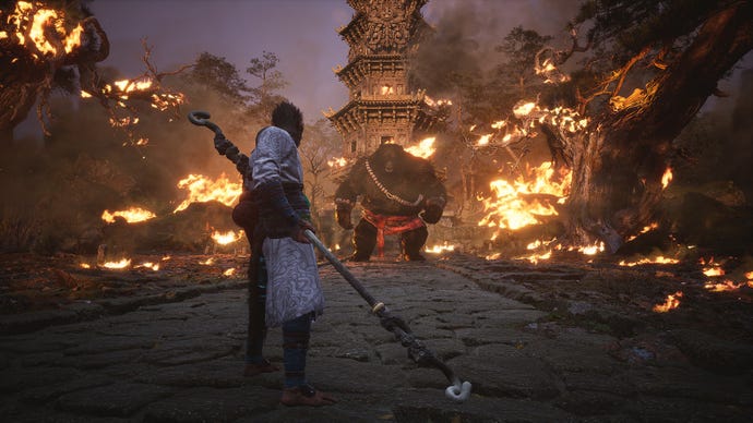 The Destined One faces Black Bear Guai in the middle of a fiery arena at the end of Black Myth: Wukong’s Chapter 1.