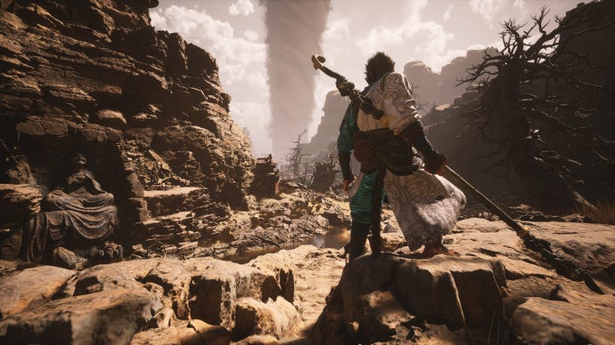 El Destinado del Mito Negro: Wukong se encuentra en un acantilado en Yellow Wind Ridge, observando un enorme tornado girando al fondo junto a una estatua de Buda y varios cañones.