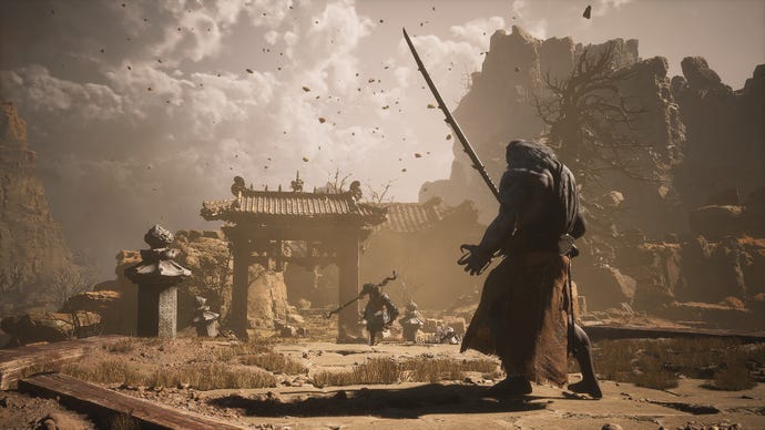 The Destined One runs towards Tiger’s Acolyte, who stands on a bridge surrounded by sandstorms in Black Myth: Wukong.