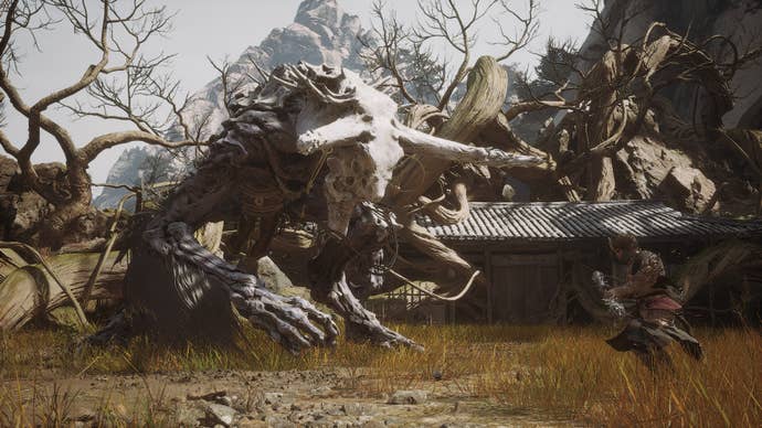 The Duskveil looms over the Destined One in Black Myth: Wukong, its skeletal head looking ominous.