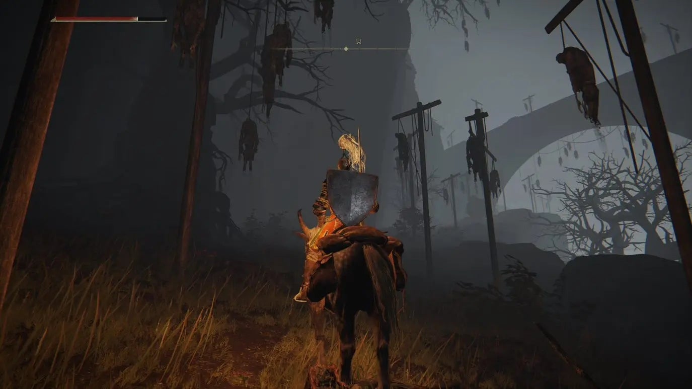 A knight on a horse approaches a dark hill with corpses strung up on crucifixes in Elden Ring