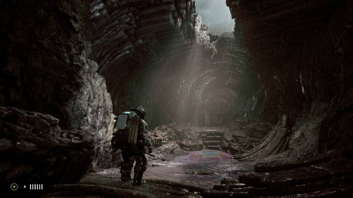 A spaceman looking up at a gap in a cave ceiling