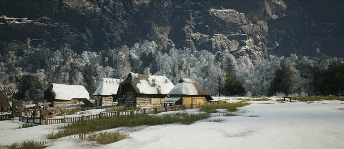 A village in Manor Lords with forest and mountains behind