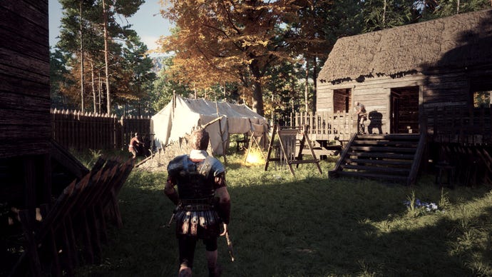 A Roman soldier walking through a player-built camp in Lost Legions
