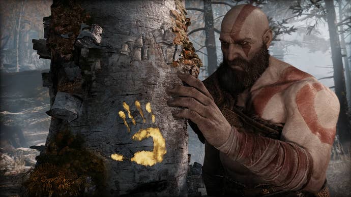 God of War screenshot showing Kratos holding a tree.
