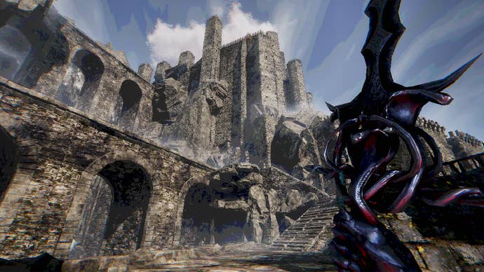 A view of tiered arched stone walls with a blue sky behind them and a big sword on the right