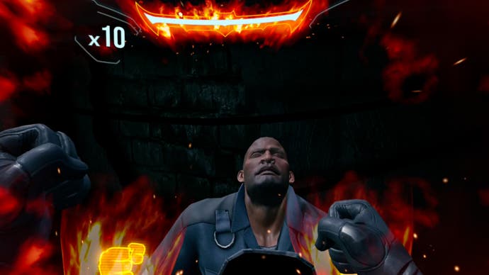 The sides of the screen are erupting into flames as Batman launches a furious fist-based finishing move on a poor hoodlum.