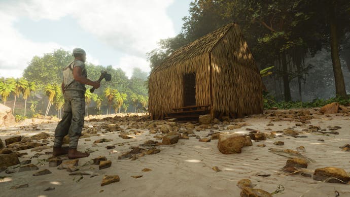 A screenshot from Ark: Survival Ascended showing the player character stood outside a simple thatch hut built on the bank of a river.