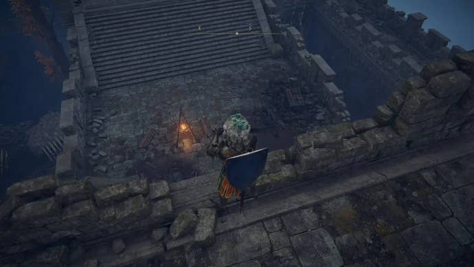 A warrior looks down on a castle walkway in Castle Morne in Elden Ring.