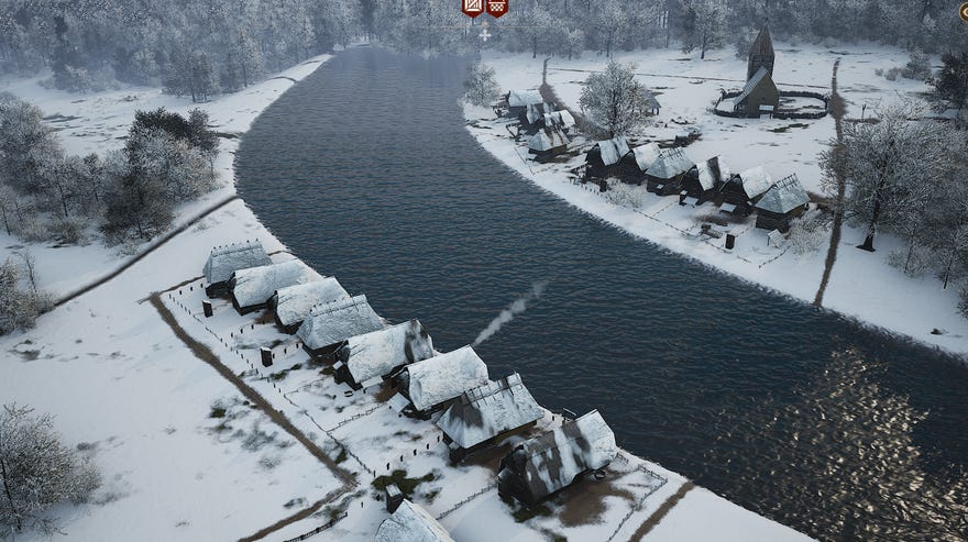 A snowy river village in Manor Lords