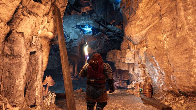 A dwarf exploring a rough cave passage in Return to Moria