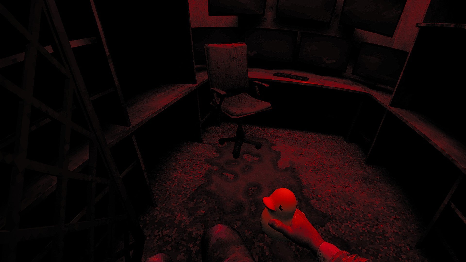 A dark red-lit room with a chair and a pool of blood and the player's hand just visible holding a rubber duck, from Ells&Pills: Chairbound. - 3