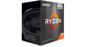 a photo of the ryzen 7 5700g APU, showing the chip in its box and the included 'wraith' cooler