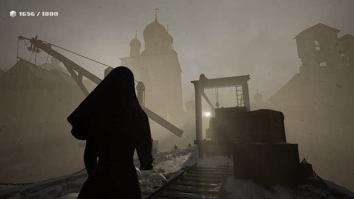 Indika screenshot showing Indika walking along abandoned rail tracks in a shadowy town
