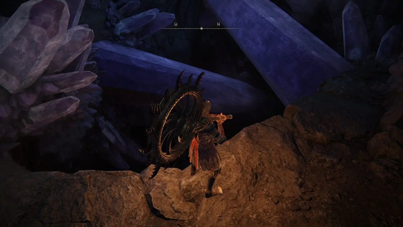 A warrior enters the Sellia Hideaway cave in Elden Ring.