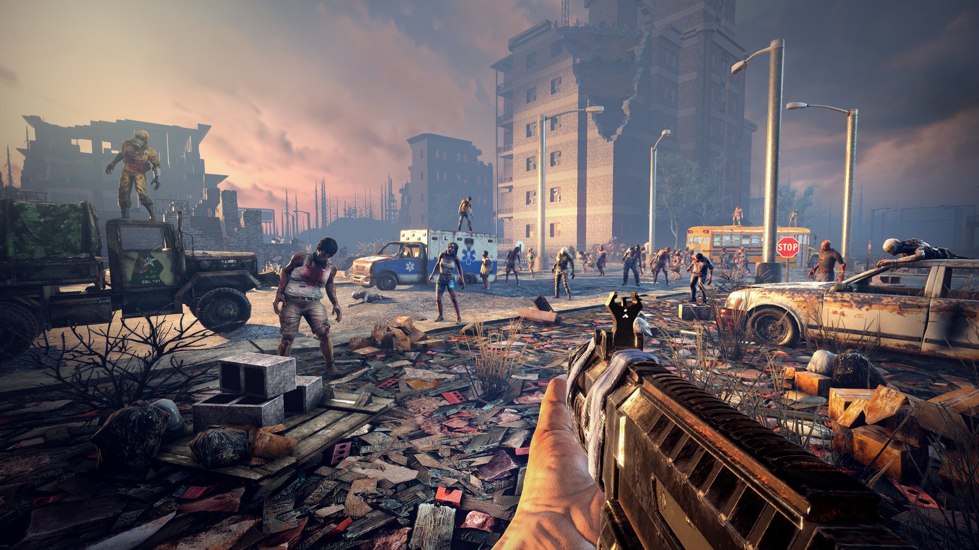 A ruined city is full of zombies, as the player points a machine gun towards them. - 1