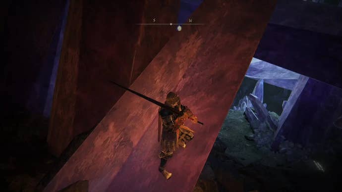 A warrior edges along a large crystal in Elden Ring.