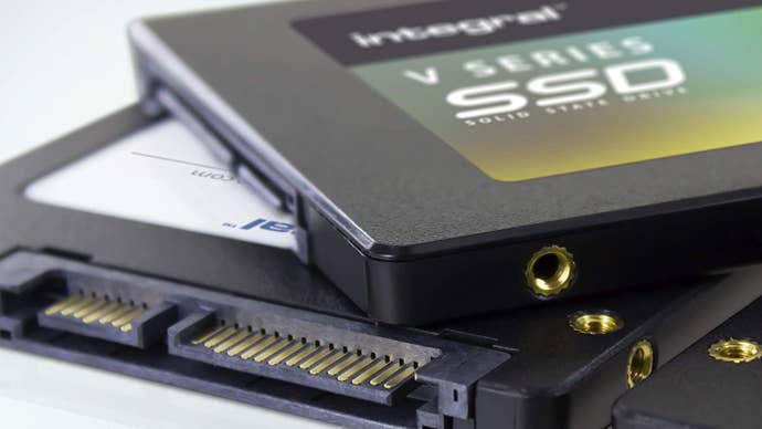 an integral v-series ssd, or two of them rather, shown in a pile.a