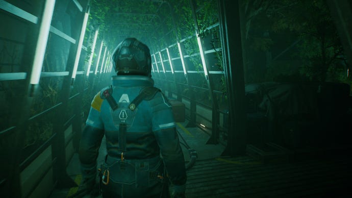 A character walking down a corridor through a greenhouse area lined with flourescent white lightbars in space sim Fort Solis.