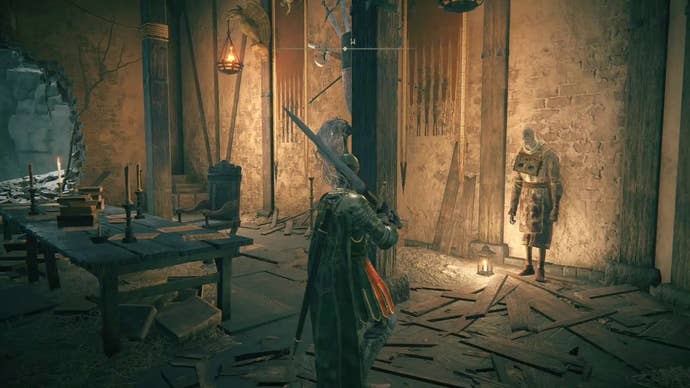 A knight meets Gostoc inside a ruined hall in Stormveil Castle in Elden Ring