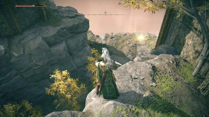 A knight looks down over a cliff toward a Site of Grace outside Stormveil Castle in Elden Ring