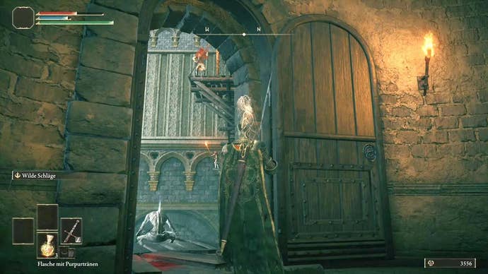 A knight stands in front of a large door to the interior of Stormveil Castle in Elden Ring