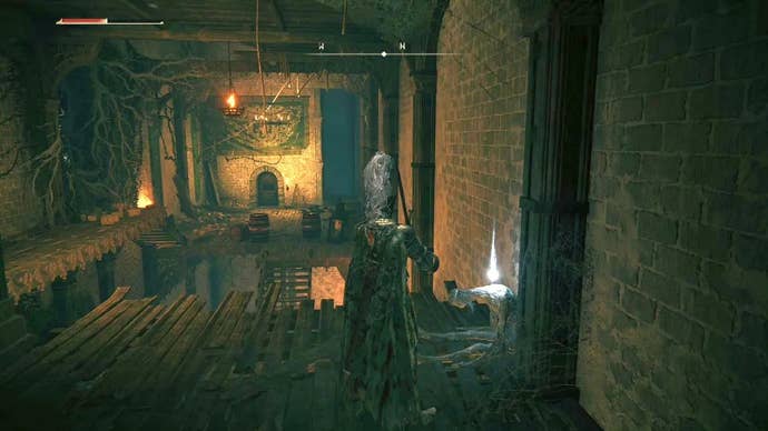 A knight stands in front of a fallen corpse inside Stormveil Castle in Elden Ring.