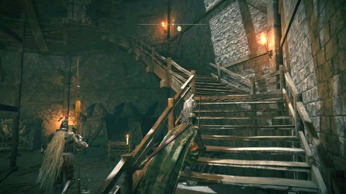 A knight runs up some wooden stairs inside Stormveil Castle in Elden Ring