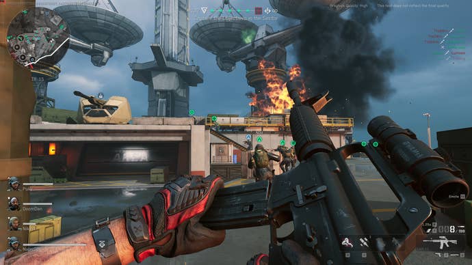A screenshot of Delta Force: Hawk Ops, showing the player reloading their weapon while the surrounding radar installation burns.