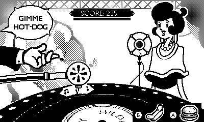 Hilda Voxpop sings in front of a turntable and microphone in DirectDrive. A hand intrudes into frame with a speech bubble that reads: “GIMME HOT-DOG”