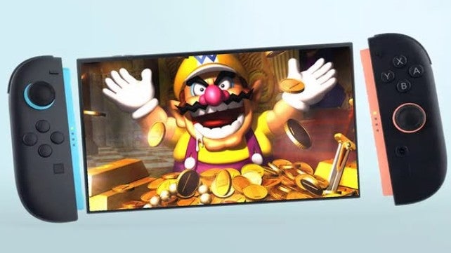 A Nintendo Switch 2 console with Wario on the screen surrounded by gold