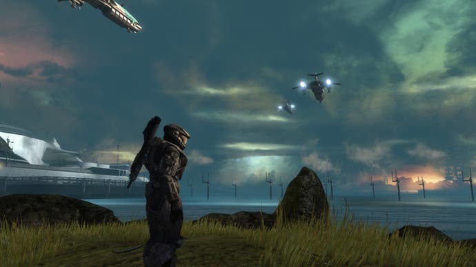 A Spartan stands in profile in front of a scene of planetary devastation in Halo: Reach