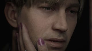 A person with pink nail polish rests James' face in their hand in Silent Hill 2 Remake