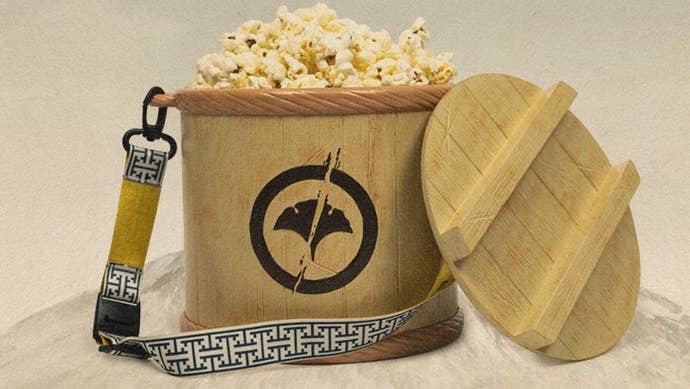 A popcorn bucket themed around Ghost of Yotei full of popcorn