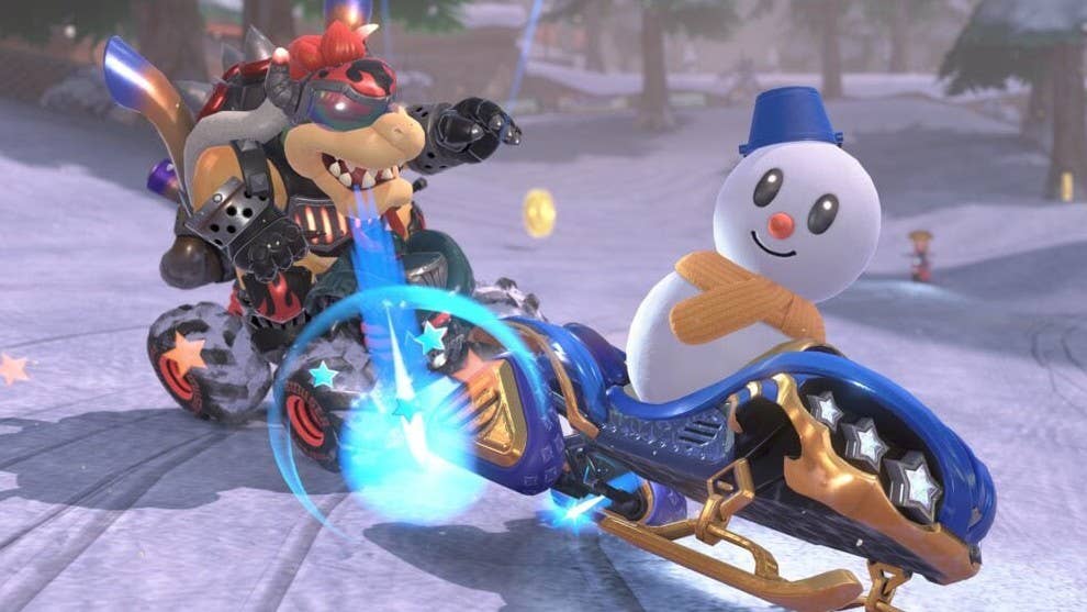 Un bonhomme de neige et Bowser font la course sur un parcours hivernal dans Mario Kart World