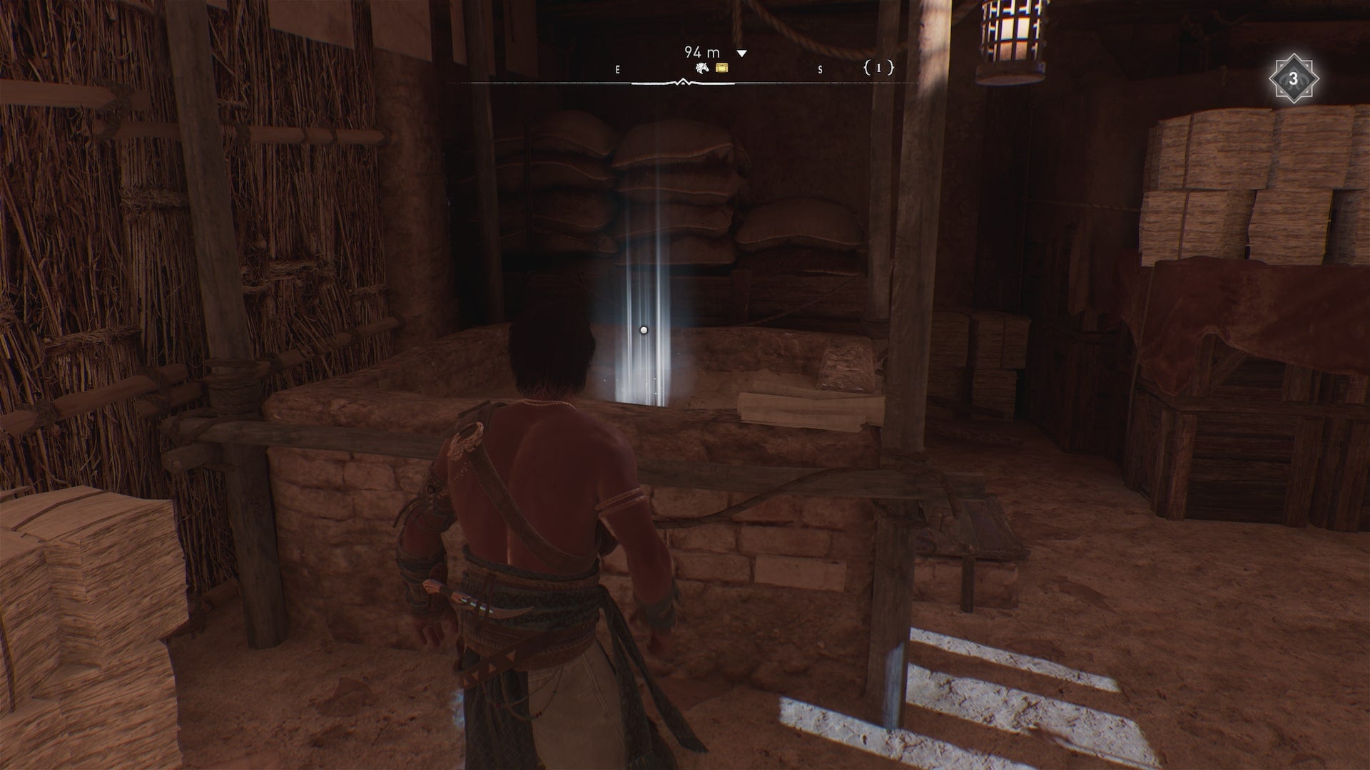 Basim stands in a barn with a treasure from the A Challenge enigma in front of him in Assassin&rsquo;s Creed Mirage