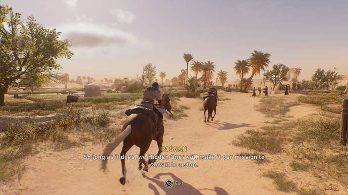 Basim and Roshan ride horses through a desert in Assassin’s Creed Mirage