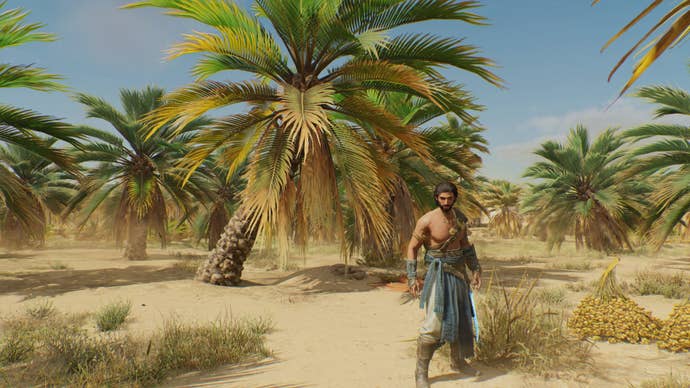 Basim stands in front of a slanted palm tree in Palm Grove in Assassin’s Creed Mirage
