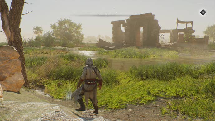 Basim faces some treasure on the ground by a tree, with some ruins in the distance in Assassin's Creed Mirage