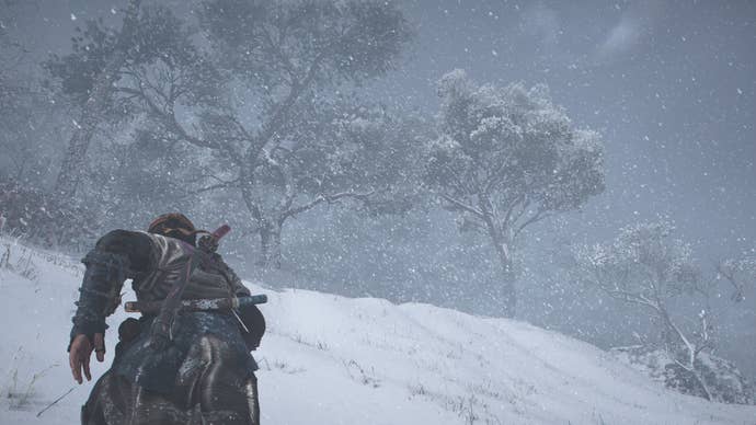 AC Shadows screenshot showing Naoe running up a snowy hill towards trees