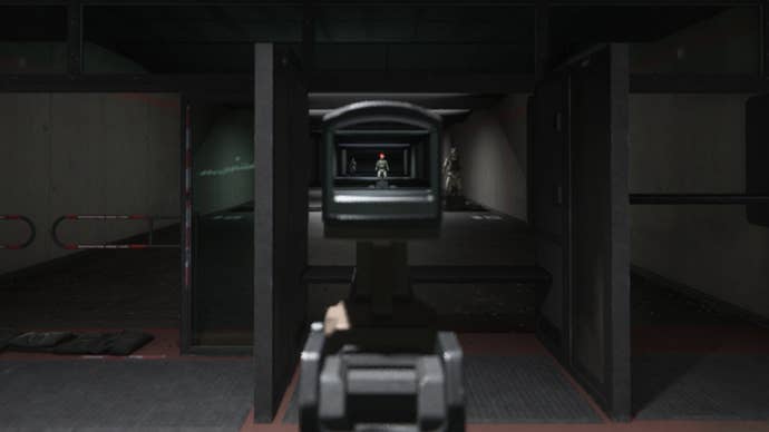 An image showing ADS aiming in Modern Warfare 3’s firing range. We zoom in on a target, giving us a precise shot but slowing movement severely.