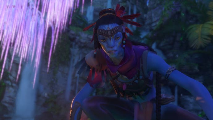 Avatar: Frontiers of Pandora screenshot showing A beautiful Na'vi dressed in purple gazes downward at something we cannot see. A fluorescent tree glows to her left.