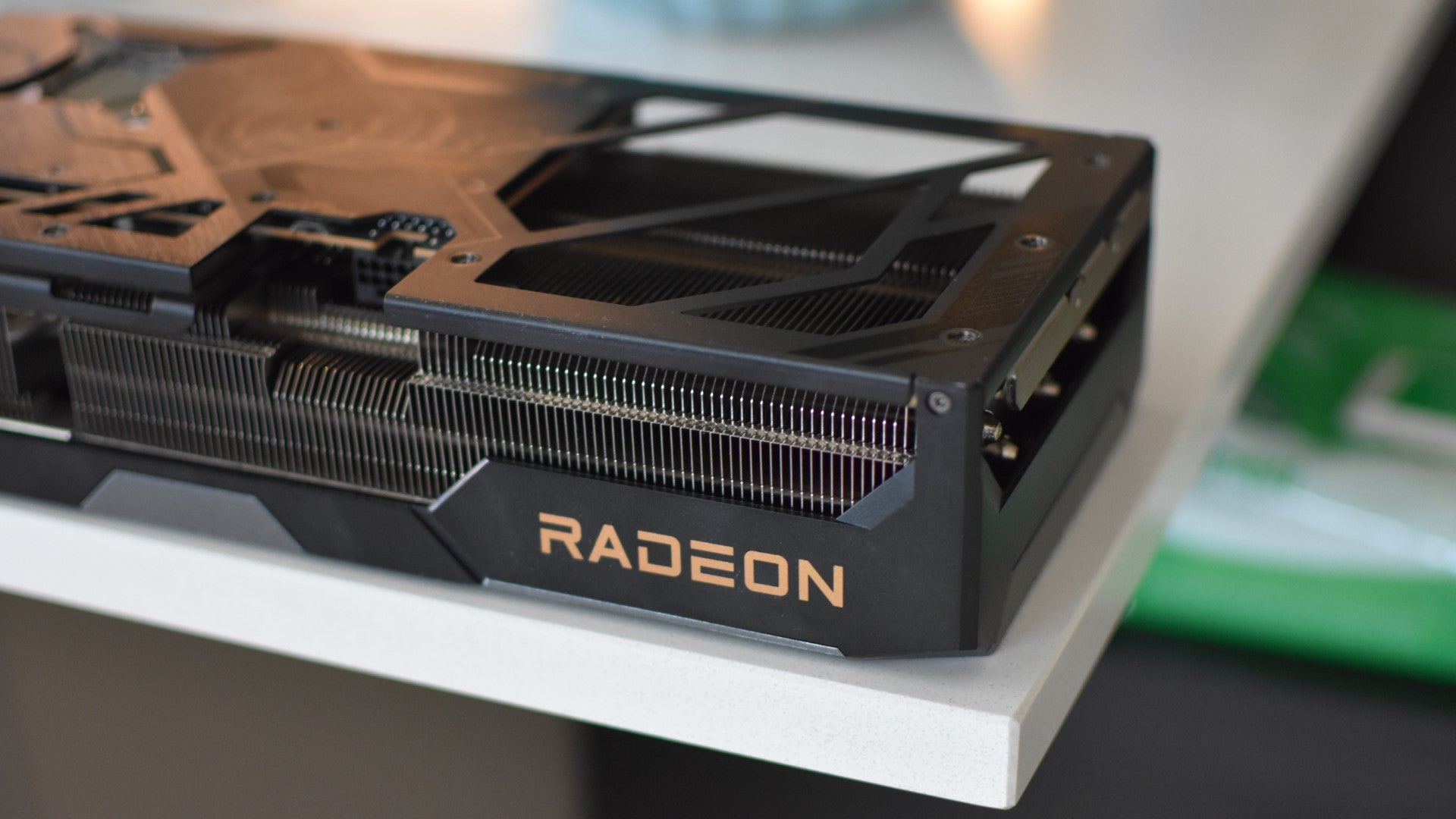 A closeup of the Radeon logo on a ASRock Radeon RX 9070 XT Taichi 16GB OC graphics card. - 8