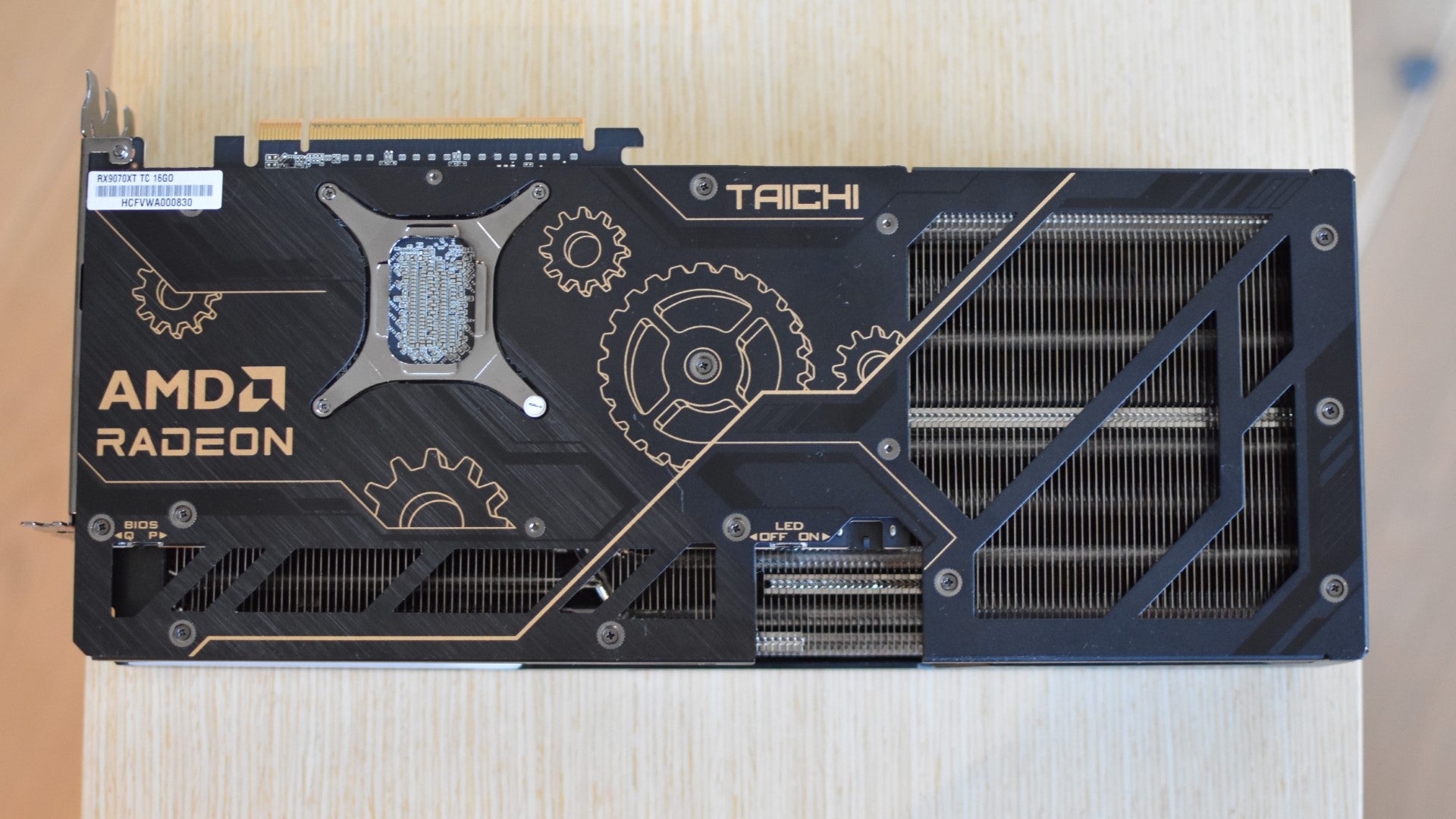 An ASRock Radeon RX 9070 XT Taichi 16GB OC lying fan side-down on a table. - 6