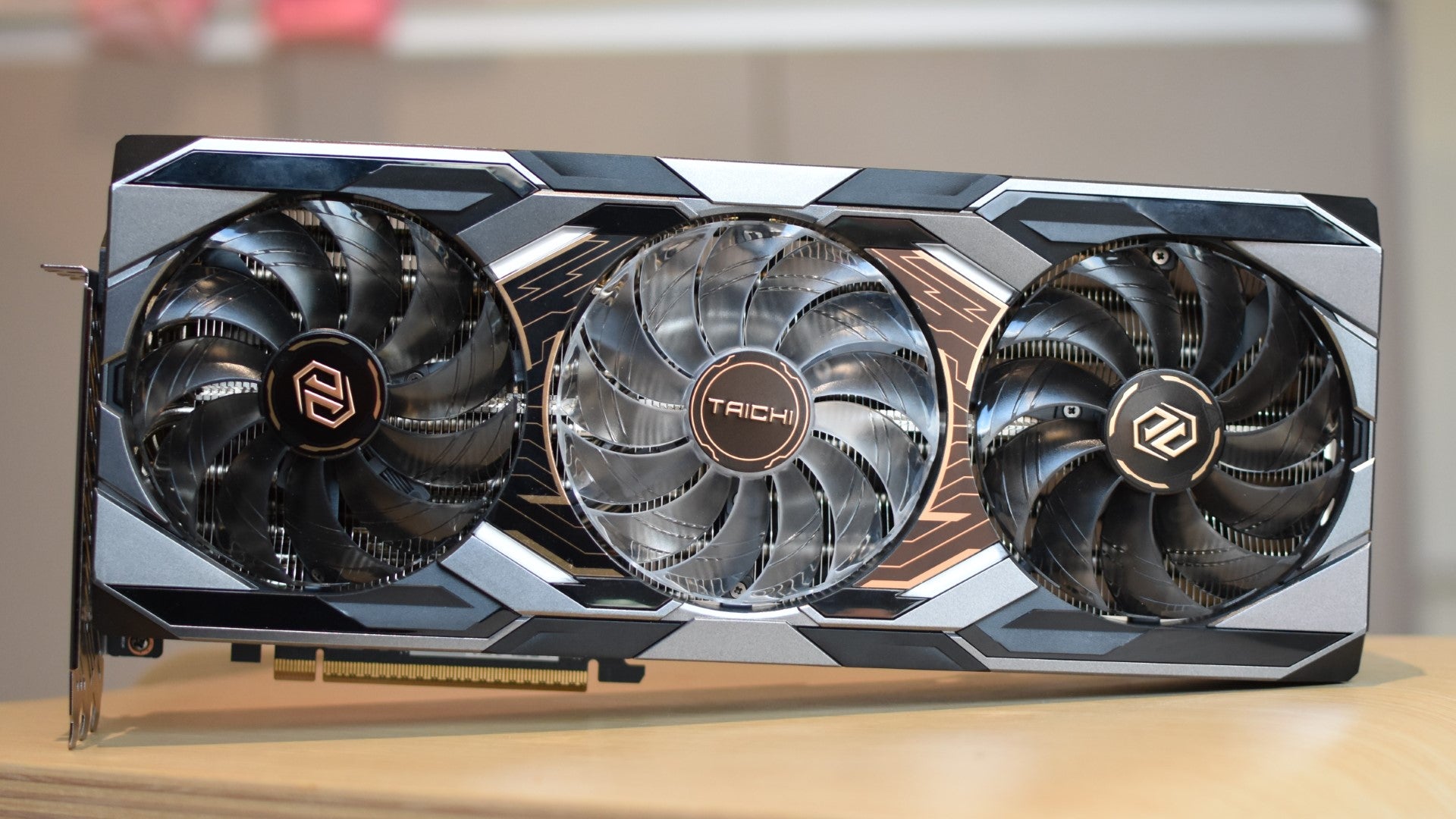 An ASRock Radeon RX 9070 XT Taichi 16GB OC graphics card on a table. - 5