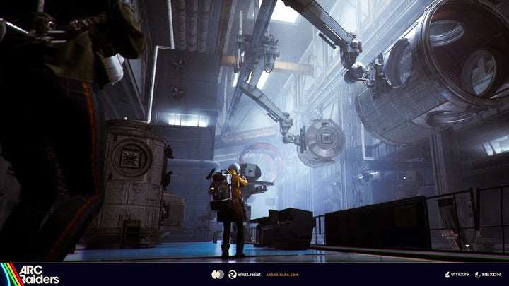 A misty cold tunnel environment in Arc Raiders from the game's Stella Montis region, showing a player looking up at some cranelike machines. - 1