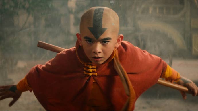 Aang, the main character from Avatar (live action show on Netflix) in a ready pose, wielding a staff.