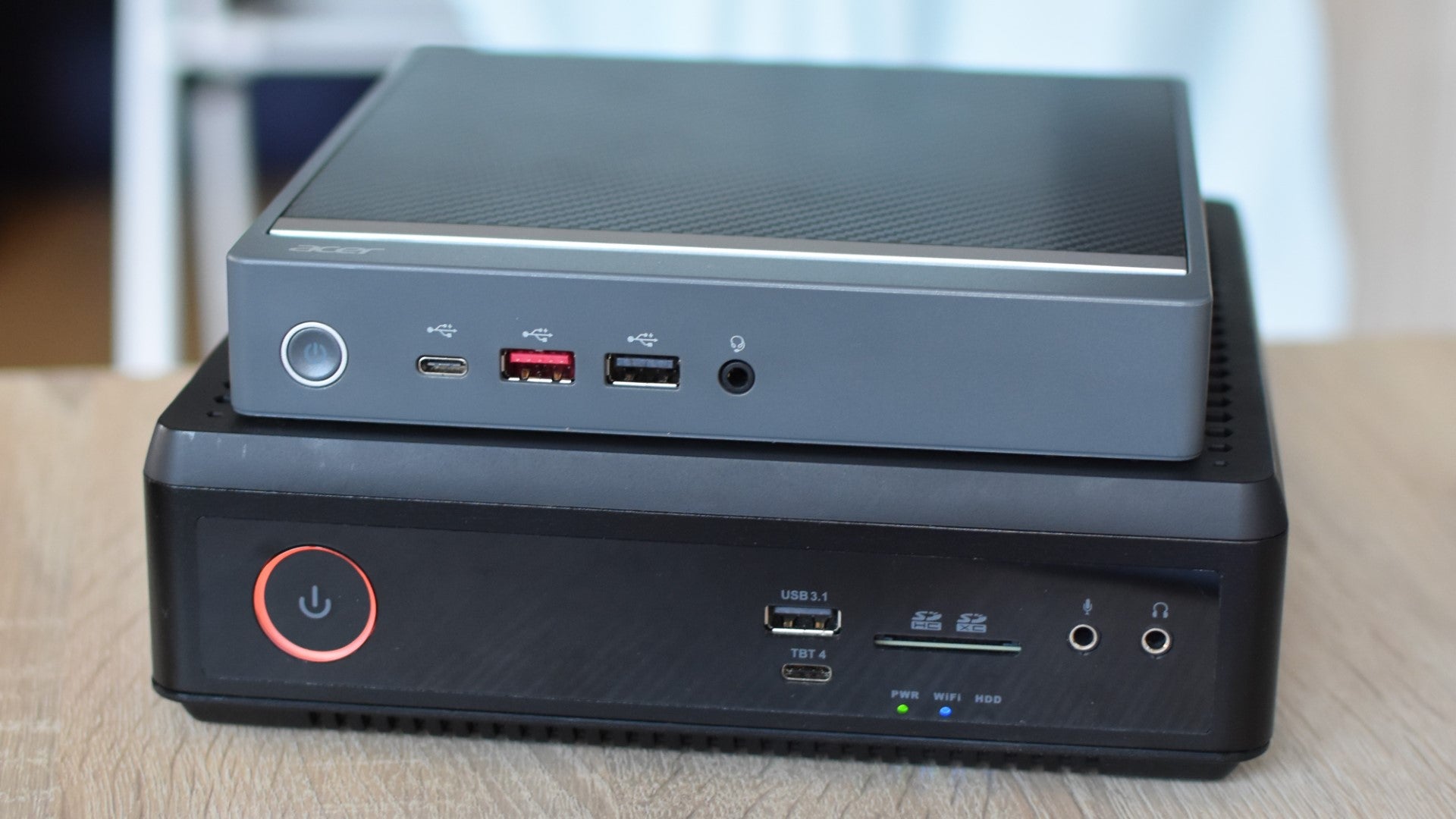 An Acer Revo Box mini PC stacked on top of a Zotac ZBOX Magnus EN374070C. - 3