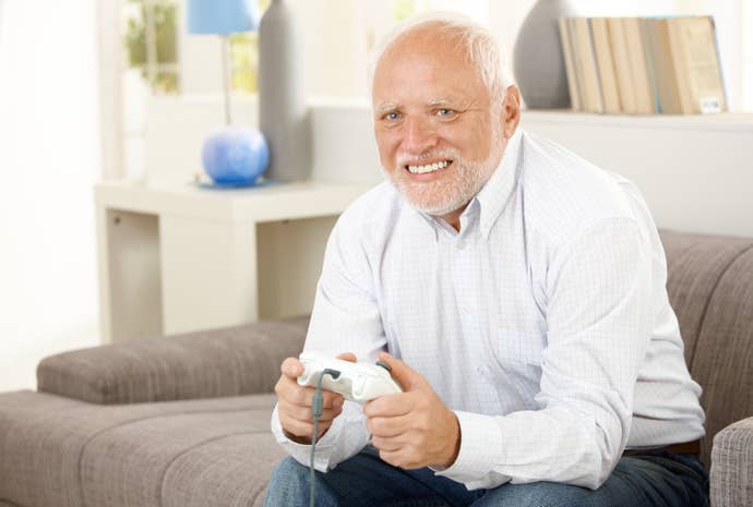 An old man with sadness in his eyes stares into the camera whilst holding an Xbox 360 controller