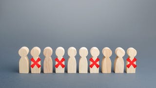 A line of wooden figures, some with red Xs in front of them